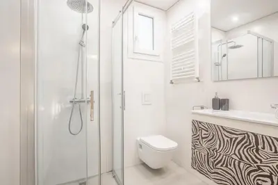 a bathroom with a shower and a toilet and a sink at Apartment Clarke in Cambridge