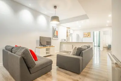 a living room with two chairs and a television at Apartment Clarke in Cambridge