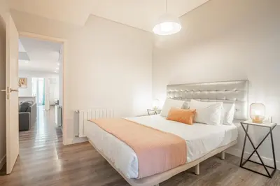 a bedroom with a large bed and a living room at Apartment Clarke in Cambridge