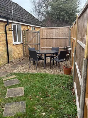 a backyard with a table and chairs and a fence at The Wright 1 bedroom place to stay large drive in East Harling