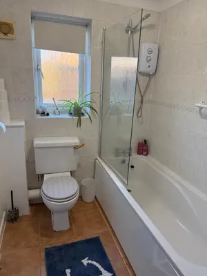 a bathroom with a toilet and a tub and a window at The Wright 1 bedroom place to stay large drive in East Harling