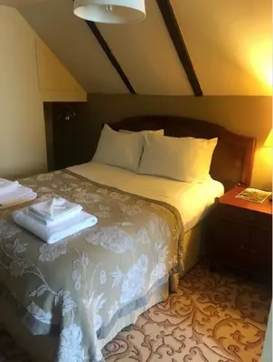 a bedroom with a bed with two towels on it at Colchester Boutique Hotel in Colchester