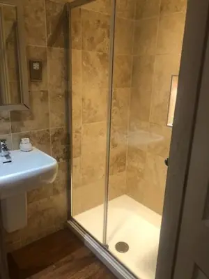 a bathroom with a shower and a sink at Colchester Boutique Hotel in Colchester