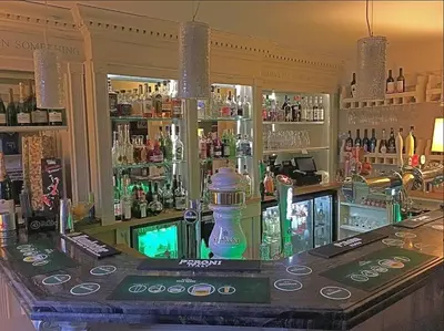 a bar with a lot of bottles of alcohol at Colchester Boutique Hotel in Colchester