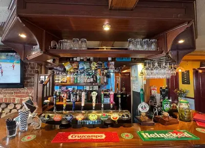 a bar with a lot of bottles of alcohol at The Jolly Brewers in Bishops Stortford