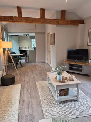 a living room with a table and a tv at The Studio at Chequers - Newly Renovated Luxury Studio in Brome