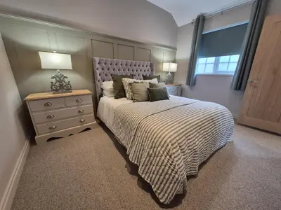 a bedroom with a bed and a nightstand and a window at The Studio at Chequers - Newly Renovated Luxury Studio in Brome