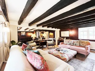 a living room with two couches and a table at Peak Hill Cottage in Theberton