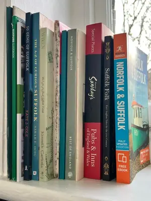 a row of books sitting on a shelf at Quiet getaway for 2 near Bury St Edmunds in Honington