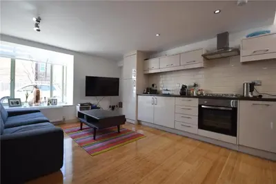 a kitchen with a couch and a table in a room at Beautiful flat in a perfect location in Cambridge