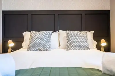 a large white bed with two pillows on it at Superb 2BR 2Bath with parking in Saxmundham
