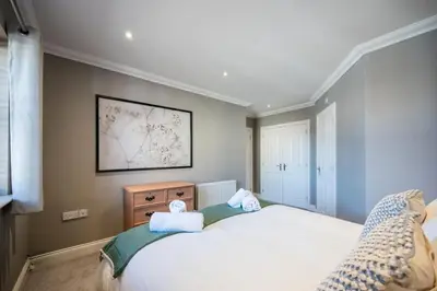 a bedroom with a bed with two towels on it at Superb 2BR 2Bath with parking in Saxmundham