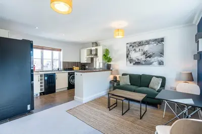 a living room with a couch and a table at Superb 2BR 2Bath with parking in Saxmundham