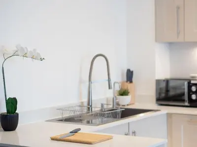 a kitchen counter with a sink and a microwave at Cosy 2-Bed Next to Harlow Town in Harlow