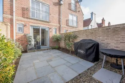 a patio in front of a brick building at North Cottage, Aldeburgh in Aldeburgh