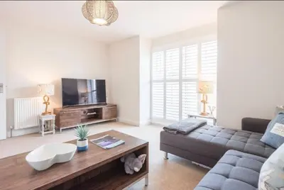 a living room with a couch and a coffee table at North Cottage, Aldeburgh in Aldeburgh