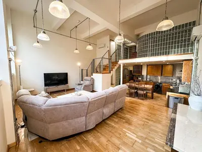 a living room with a couch and a kitchen at Portman Business & Leisure Duplex in Ipswich
