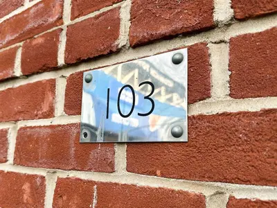 a clock on the side of a brick wall at Portman Business & Leisure Duplex in Ipswich