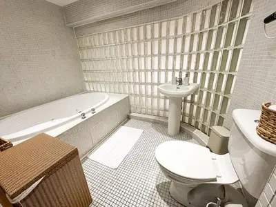 a bathroom with a toilet and a tub and a sink at Portman Business & Leisure Duplex in Ipswich