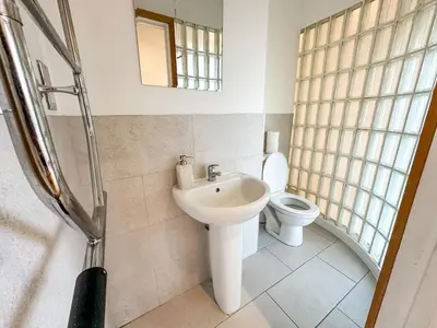 a bathroom with a sink and a toilet at Portman Business & Leisure Duplex in Ipswich