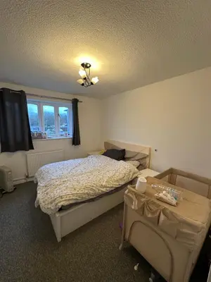 a bedroom with a bed and a table at Aneliya home in Enfield