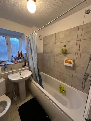 a bathroom with a tub and a sink and a toilet at Aneliya home in Enfield