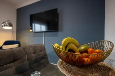 a bowl of fruit on a table in a living room at Shrub End Lodge - Colchester in Lexden