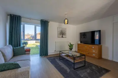 a living room with a couch and a tv at Sizewell - Lincoln - Contractor Accommodation in Saxmundham