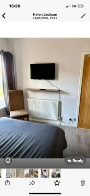 a bedroom with a bed and a tv on a wall at Leiston house in Leiston