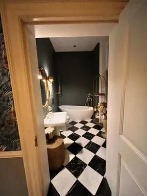a bathroom with a black and white checkered floor at Herringswell Manor in Red Lodge