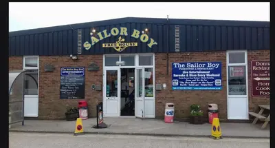 a store front of a shop with the door open at Tracis home from home in Jaywick Sands