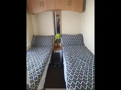 two beds in a small room with at Tracis home from home in Jaywick Sands