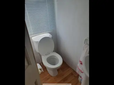 a bathroom with a white toilet in a room at Tracis home from home in Jaywick Sands