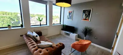 a living room with a couch and two chairs at Stylish 2 Bedroom Flat near Chelmsford Station, with Free Parking, Sleeps 4 in Chelmsford