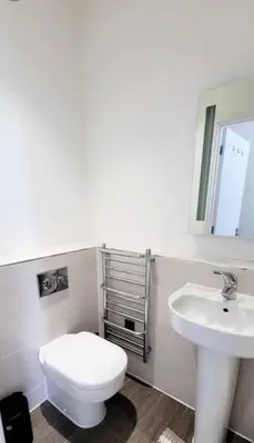 a bathroom with a white toilet and a sink at Stylish 2 Bedroom Flat near Chelmsford Station, with Free Parking, Sleeps 4 in Chelmsford