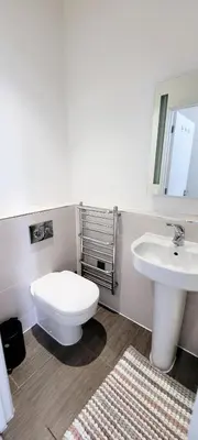 a bathroom with a white toilet and a sink at Stylish 2 Bedroom Flat near Chelmsford Station, with Free Parking, Sleeps 4 in Chelmsford