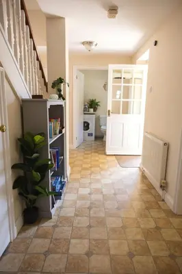 a hallway with a staircase and a floor at Cosy Rural Retreat Perfect for Families and Pets in Tuddenham