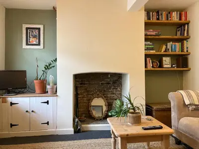 a living room with a fireplace and a couch at Charming Cambridgeshire Home in Ely