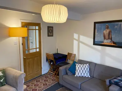 a living room with a couch and a chair at Charming Cambridgeshire Home in Ely