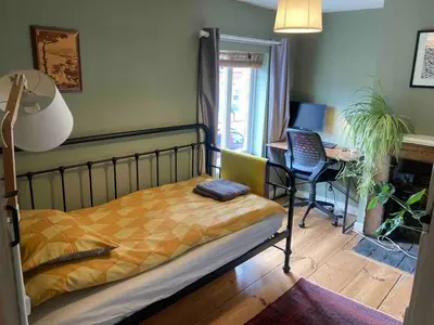 a bedroom with a bed and a desk with a computer at Charming Cambridgeshire Home in Ely