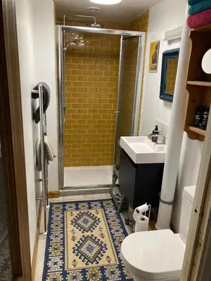 a bathroom with a shower and a toilet and a sink at Charming Cambridgeshire Home in Ely