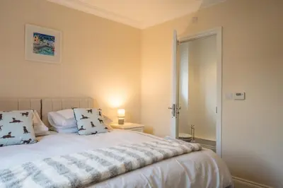 a bedroom with a bed with pillows on it at Comfortable 2-Bedroom Home in Framlingham in Framlingham