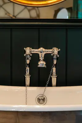 a silver faucet with a chain on a sink at Eagle Mill Luxury Rooms in Huntingdon