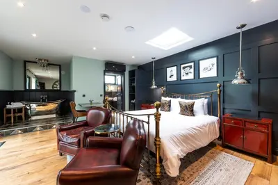 a bedroom with a bed and a living room at Eagle Mill Luxury Rooms in Huntingdon