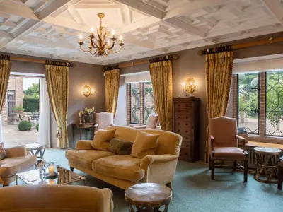 a living room with a couch and chairs at The Old Hall Ely in Ely