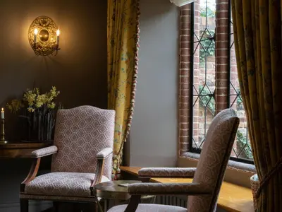 a room with two chairs and a table and a window at The Old Hall Ely in Ely