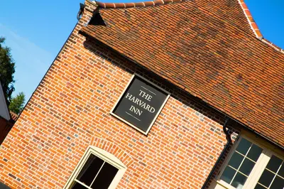 a sign on the side of a brick building at The Harvard Inn in Stock