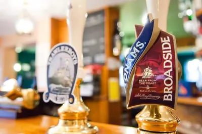 two bottles of alcohol sitting on top of a table at The Dolphin Inn in Thorpeness