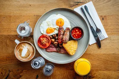 a plate of breakfast food with eggs sausage and toast at Crown & Punchbowl in Cambridge
