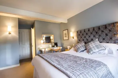 a bedroom with a large bed and a mirror at Crown & Punchbowl in Cambridge